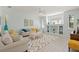 Bright living room features a built-in shelving unit, white trim, and a colorful area rug at 8956 Stone Harbour Loop, Bradenton, FL 34212