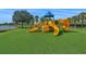 Vibrant playground with slides and climbing structures on a green turf surface at 8956 Stone Harbour Loop, Bradenton, FL 34212