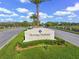 Welcoming entrance sign to Heritage Harbour amidst beautiful landscaping and palm trees at 8956 Stone Harbour Loop, Bradenton, FL 34212