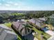 Aerial view of a single Gathering home with lush backyard landscaping overlooking a pond at 914 Regal Manor Way, Sun City Center, FL 33573