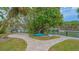 Tranquil backyard oasis with a waterfront view, a sitting area, and lush greenery at 940 Siesta Key Pl, Sarasota, FL 34242