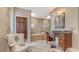 Elegant bathroom features a soaking tub, shower, vanity, and seating area for a relaxing spa-like experience at 940 Siesta Key Pl, Sarasota, FL 34242