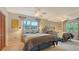 Comfortable bedroom with two beds, ceiling fans, and ample natural light at 940 Siesta Key Pl, Sarasota, FL 34242
