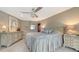 Spacious bedroom featuring a decorative ceiling fan, a painted dresser, and soft, neutral tones at 940 Siesta Key Pl, Sarasota, FL 34242