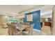 Spacious dining area connected to other living spaces, enhanced by a unique blue accent wall at 940 Siesta Key Pl, Sarasota, FL 34242