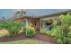 Beautiful exterior with professional landscaping, showcasing vibrant plants and a serene setting at 940 Siesta Key Pl, Sarasota, FL 34242