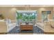 Bright living room featuring elegant seating arrangements, a cozy rug, and natural light at 940 Siesta Key Pl, Sarasota, FL 34242