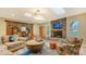 Inviting living room featuring a stone fireplace, skylights and comfortable seating arrangements at 940 Siesta Key Pl, Sarasota, FL 34242