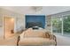 Comfortable main bedroom with plush seating, a stylish bed, and views of the outside greenery at 940 Siesta Key Pl, Sarasota, FL 34242