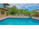 Serene swimming pool surrounded by lush tropical landscaping and comfortable lounge seating at 940 Siesta Key Pl, Sarasota, FL 34242