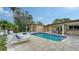 Inviting swimming pool with tiled patio and comfortable lounge chairs by the water at 940 Siesta Key Pl, Sarasota, FL 34242