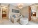 Cozy sitting area with a comfortable couch, ottoman, and chandelier lighting at 940 Siesta Key Pl, Sarasota, FL 34242