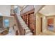 Staircase with carpet steps, built-in shelving, and natural lighting, adding architectural detail at 940 Siesta Key Pl, Sarasota, FL 34242