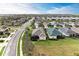 Aerial view of the home showcasing its well-manicured lawn and proximity to a quiet residential street at 12343 Halfmoon Lake Ter, Bradenton, FL 34211