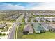 Expansive aerial view of a well-manicured housing community with ponds and mature trees at 12343 Halfmoon Lake Ter, Bradenton, FL 34211