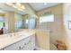 Modern bathroom with a tiled shower, vanity, a frameless glass shower door, and white countertops at 12343 Halfmoon Lake Ter, Bradenton, FL 34211