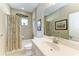 Bathroom features a large mirror, shower/tub combo, and a neutral color palette at 12343 Halfmoon Lake Ter, Bradenton, FL 34211