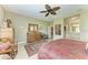 Cozy bedroom with a ceiling fan and a view leading into a connected bathroom at 12343 Halfmoon Lake Ter, Bradenton, FL 34211