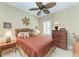 Cozy bedroom features a ceiling fan, neutral walls, and ample natural light at 12343 Halfmoon Lake Ter, Bradenton, FL 34211