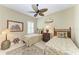 This bright bedroom features two twin beds, ceiling fan, and an area rug at 12343 Halfmoon Lake Ter, Bradenton, FL 34211