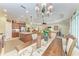 Open-concept dining room featuring chandelier and a view of the kitchen and living area at 12343 Halfmoon Lake Ter, Bradenton, FL 34211