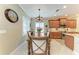 Dining area next to the kitchen, featuring a chandelier and a wooden dining table at 12343 Halfmoon Lake Ter, Bradenton, FL 34211