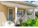 Quaint front porch with seating, a decorative wreath, and a pop of color at 12343 Halfmoon Lake Ter, Bradenton, FL 34211