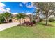 Inviting home with a well-manicured lawn, mature tree, and colorful landscaping at 12343 Halfmoon Lake Ter, Bradenton, FL 34211