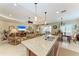Island kitchen with open layout to the living room featuring stainless steel sink at 12343 Halfmoon Lake Ter, Bradenton, FL 34211