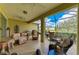 This screened lanai features an outdoor dining and seating area with grill at 12343 Halfmoon Lake Ter, Bradenton, FL 34211