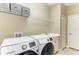 This laundry room features a newer washer and dryer and storage shelving at 12343 Halfmoon Lake Ter, Bradenton, FL 34211