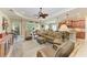 Bright living room with neutral tones, ceiling fan, and natural light flowing in from the exterior at 12343 Halfmoon Lake Ter, Bradenton, FL 34211