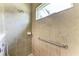 This shower features neutral tile, grab bar, and a sunny window at 12343 Halfmoon Lake Ter, Bradenton, FL 34211