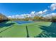 Community tennis court with bright blue surface and well-maintained green surroundings at 12343 Halfmoon Lake Ter, Bradenton, FL 34211