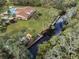 Aerial view of the property featuring a community center, pool, and waterway with kayak dock at 1239 Pinebrook Way, Venice, FL 34285