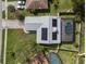 Aerial view of home with solar panels and screened-in pool at 1239 Pinebrook Way, Venice, FL 34285