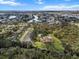 Wide aerial view of residential area highlighting community amenities: pool, tennis courts, and waterway access at 1239 Pinebrook Way, Venice, FL 34285