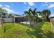 Landscaped backyard with a screened-in pool offers privacy and relaxation at 1239 Pinebrook Way, Venice, FL 34285
