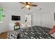 Comfortable bedroom with a ceiling fan and a TV, providing a relaxing and modern living space at 1239 Pinebrook Way, Venice, FL 34285