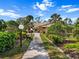Exterior view of community center with lush landscaping at 1239 Pinebrook Way, Venice, FL 34285
