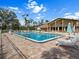 A spacious community pool area with ample seating and lounging options at 1239 Pinebrook Way, Venice, FL 34285