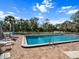 Relaxing community pool area with lounge chairs and shaded seating at 1239 Pinebrook Way, Venice, FL 34285