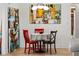 Bright dining area featuring modern artwork and a stylish three-light pendant over the table at 1239 Pinebrook Way, Venice, FL 34285