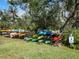 Kayak storage rack on grassy area, promoting outdoor activities with easy access to nearby waterways at 1239 Pinebrook Way, Venice, FL 34285