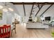 Open-concept living room with vaulted ceilings, exposed wood beams, and lots of natural light at 1239 Pinebrook Way, Venice, FL 34285