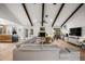 Open-concept living area with a fireplace, vaulted ceilings, and views of the kitchen and backyard at 1239 Pinebrook Way, Venice, FL 34285