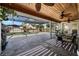 Screened-in patio with ceiling fans, stone floors, and outdoor seating, adjacent to a pool at 1239 Pinebrook Way, Venice, FL 34285