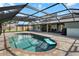 Backyard pool area featuring a screened-in pool, patio, and outdoor seating, perfect for relaxation at 1239 Pinebrook Way, Venice, FL 34285