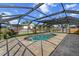 In-ground pool with screened enclosure, set in a well-maintained backyard with mature trees and landscaping at 1239 Pinebrook Way, Venice, FL 34285