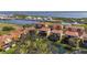 Drone shot showcases a neighborhood with red-tiled roofs near a beautiful body of water at 1308 3Rd Street E Cir, Palmetto, FL 34221